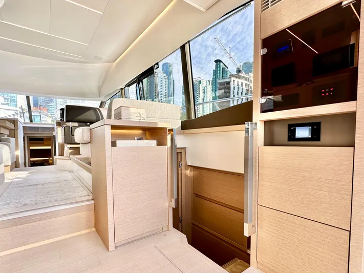 Pearl Voyage Yacht Photos Pics Luxurious interior of 2023 Prestige 520 yacht with modern design and cityscape view.
