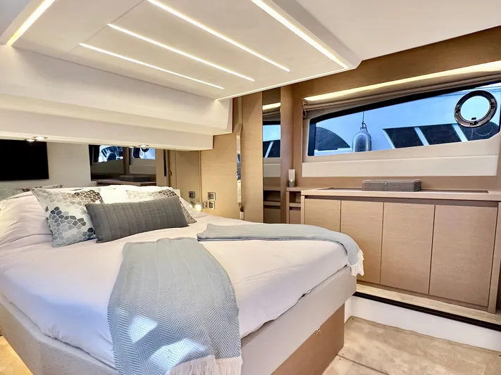 Pearl Voyage Yacht Photos Pics Luxurious bedroom interior of 2023 Prestige 520 yacht with modern design and elegant furnishings.