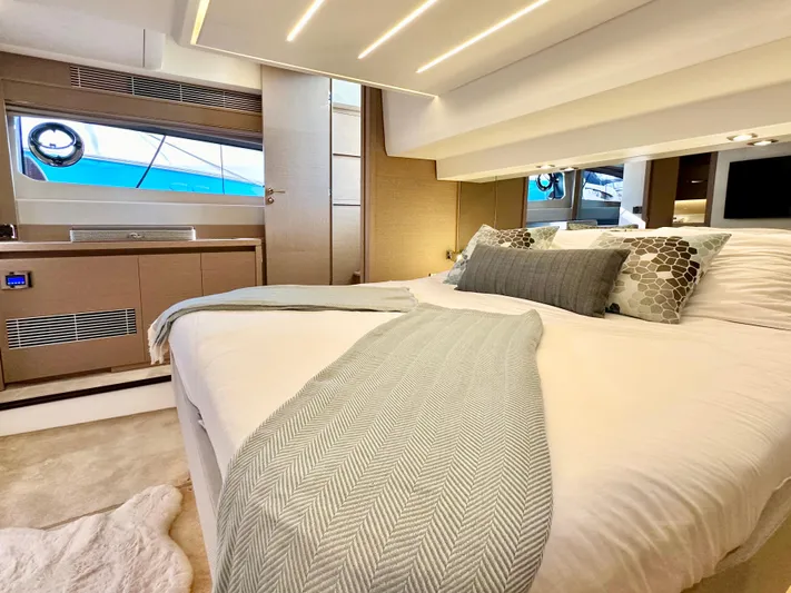 Pearl Voyage Yacht Photos Pics Luxurious bedroom interior of 2023 Prestige 520 yacht with modern design and elegant decor.
