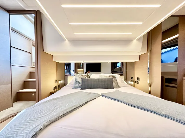 Pearl Voyage Yacht Photos Pics Luxurious bedroom interior of 2023 Prestige 520 yacht, featuring modern design and elegant lighting.