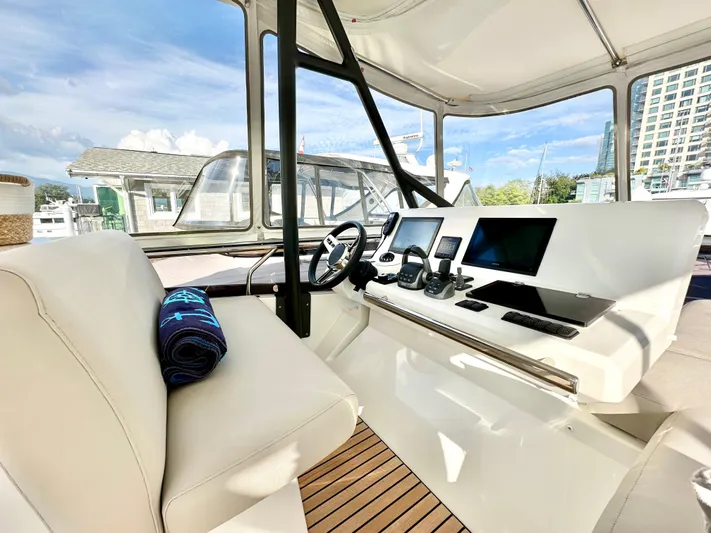 Pearl Voyage Yacht Photos Pics Luxurious 2023 Prestige 520 yacht helm with modern navigation equipment and plush seating.