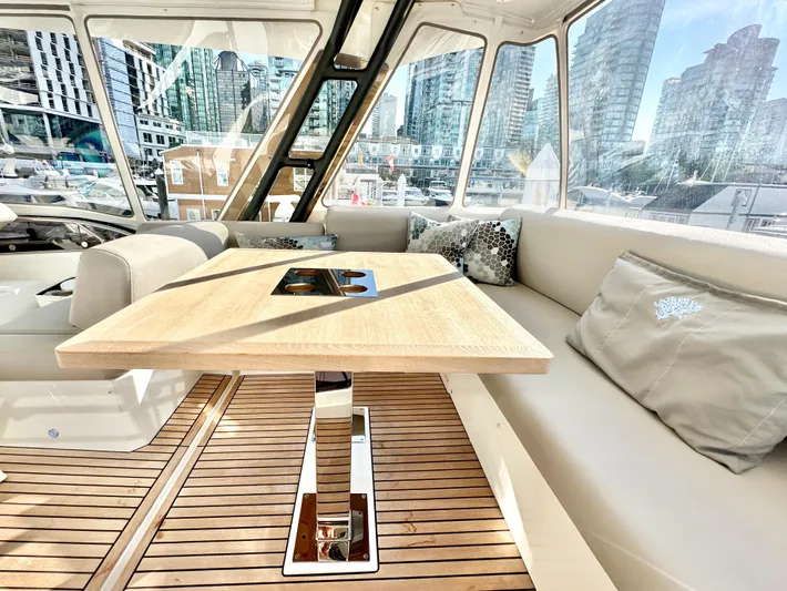 Pearl Voyage Yacht Photos Pics Luxurious interior of 2023 Prestige 520 yacht with cityscape view.