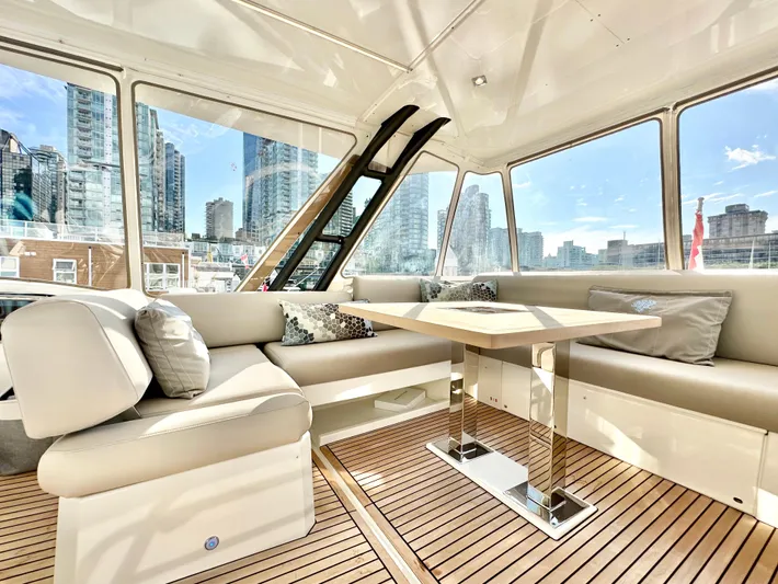 Pearl Voyage Yacht Photos Pics Luxurious interior of 2023 Prestige 520 yacht with city skyline view.
