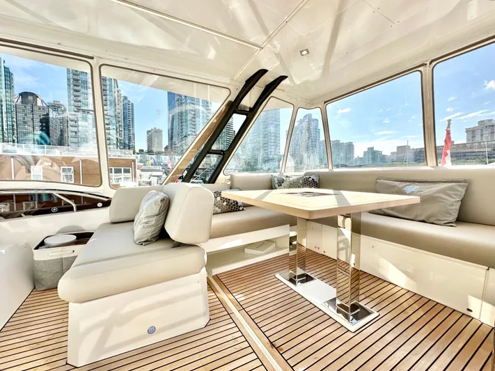 Pearl Voyage Yacht Photos Pics Luxurious interior of 2023 Prestige 520 yacht with city skyline view.