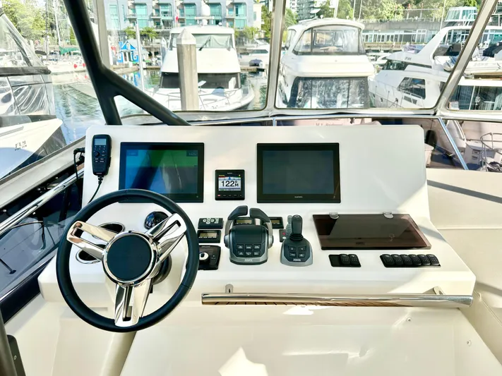Pearl Voyage Yacht Photos Pics Helm of 2023 Prestige 520 yacht with modern navigation equipment and steering wheel.