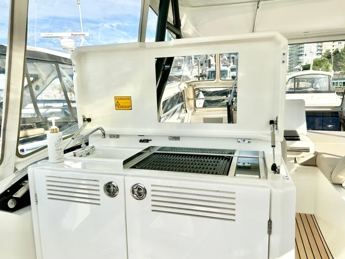 Pearl Voyage Yacht Photos Pics Outdoor kitchen on 2023 Prestige 520 yacht with grill and sink.