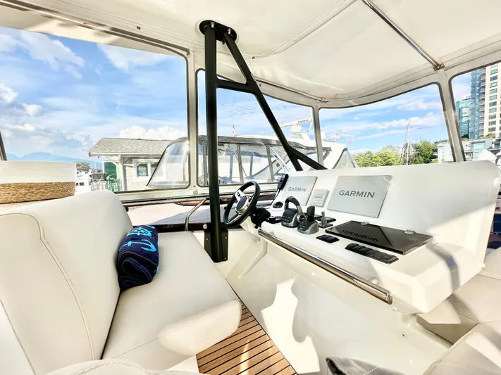 Pearl Voyage Yacht Photos Pics Interior of 2023 Prestige 520 yacht with modern navigation equipment and luxurious seating.