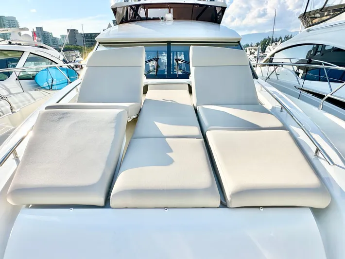 Pearl Voyage Yacht Photos Pics Luxurious 2023 Prestige 520 yacht with spacious sunbathing deck in marina setting.