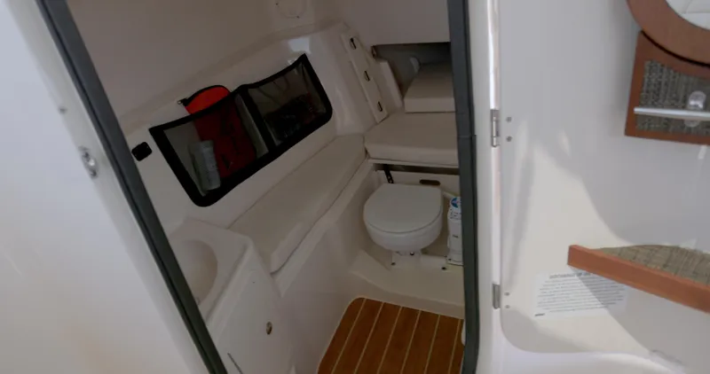  Yacht Photos Pics 2018 Grady-White Freedom 307 boat interior with toilet and seating area.