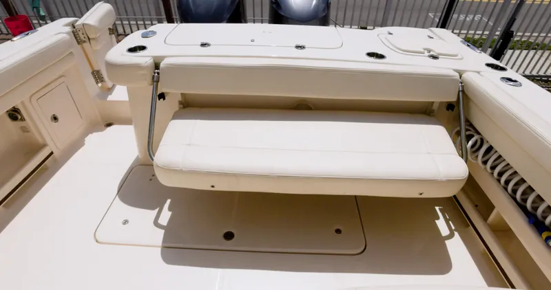  Yacht Photos Pics 2018 Grady-White Freedom 307 boat interior with beige seating and storage compartments.