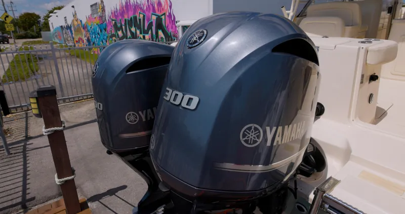  Yacht Photos Pics Twin Yamaha 300 engines on a 2018 Grady-White Freedom 307 boat, with colorful graffiti background.