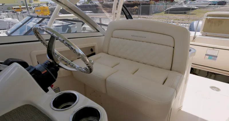  Yacht Photos Pics 2018 Grady-White Freedom 307 boat interior with steering wheel and cushioned seating.