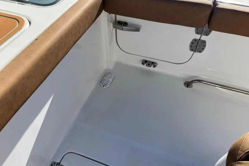  Yacht Photos Pics 2021 Sea Hunt Gamefish 27 Coffin Box interior with brown seating and white deck.