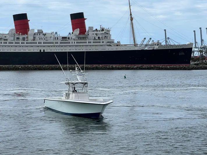 Part Time Hooker Yacht Photos Pics 2009 SeaVee IPS boat cruising near a large ocean liner in a harbor.