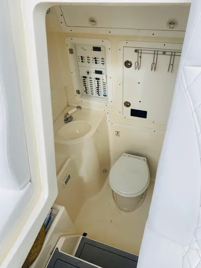 Part Time Hooker Yacht Photos Pics 2009 SeaVee IPS boat interior with toilet, sink, and control panel.