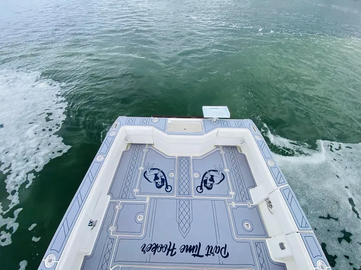 Part Time Hooker Yacht Photos Pics 2009 SeaVee IPS boat deck with custom design on calm water.