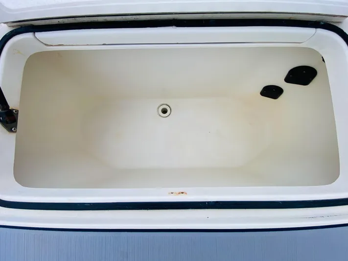 Part Time Hooker Yacht Photos Pics 2009 SeaVee IPS boat storage compartment, open and empty, with drain plug visible.