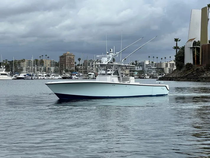 Part Time Hooker Yacht Photos Pics 2009 SeaVee IPS boat on calm water with cityscape background.