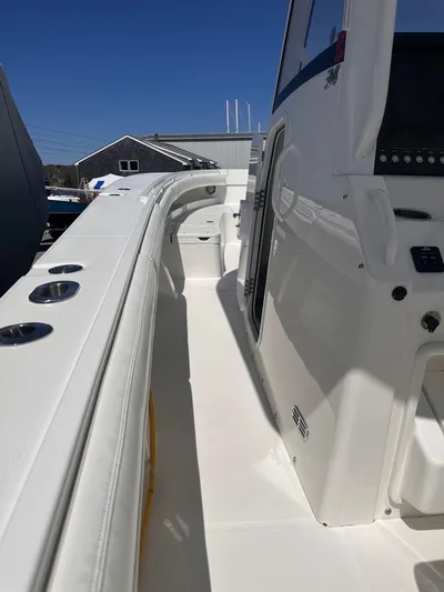 Three Ladies Yacht Photos Pics 2021 Regulator 34 boat deck with sleek white design and modern controls.