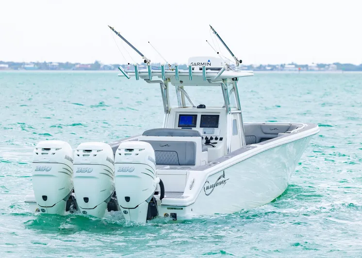  Yacht Photos Pics 2021 Blackwater 36 Sport boat with triple engines on open water.