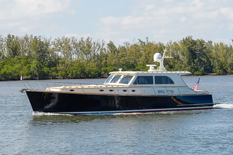 Holly Ann Yacht Photos Pics 2010 Vicem 58/64 yacht cruising on a calm river with lush greenery in the background.