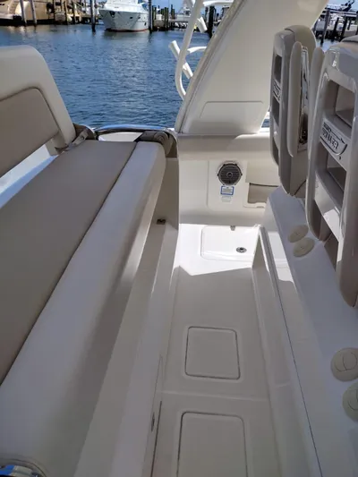Inspiration II Yacht Photos Pics 2018 Boston Whaler 420 Outrage interior with seating and storage, docked by the water.