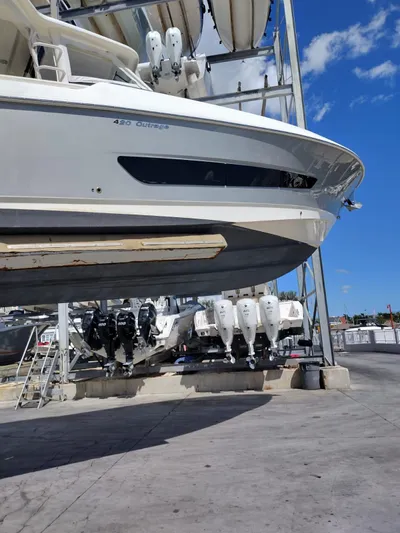 Inspiration II Yacht Photos Pics 2018 Boston Whaler 420 Outrage boat in dry dock, showcasing sleek design and powerful engines.