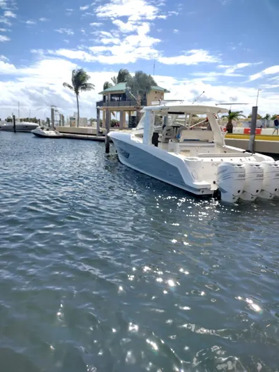 Inspiration II Yacht Photos Pics 2018 Boston Whaler 420 Outrage docked in sunny marina with palm trees.