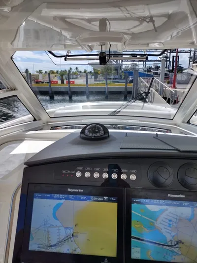 Inspiration II Yacht Photos Pics 2018 Boston Whaler 420 Outrage helm with navigation screens and compass, docked at marina.