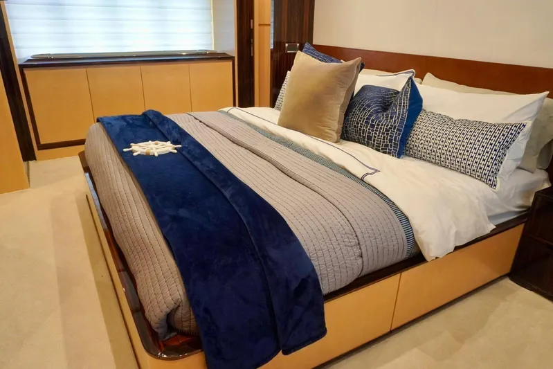  Yacht Photos Pics Luxurious bedroom interior on a 2015 Azimut 84 yacht, featuring elegant bedding and decor.