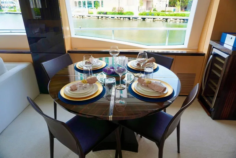  Yacht Photos Pics Luxurious dining setup on 2015 Azimut 84 yacht, featuring elegant tableware and waterfront view.