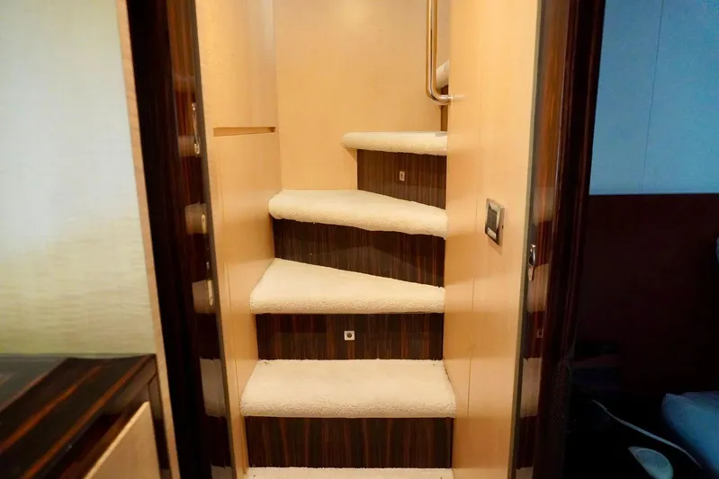 Yacht Photos Pics Staircase inside 2015 Azimut 84 yacht, featuring plush carpeting and sleek wooden accents.