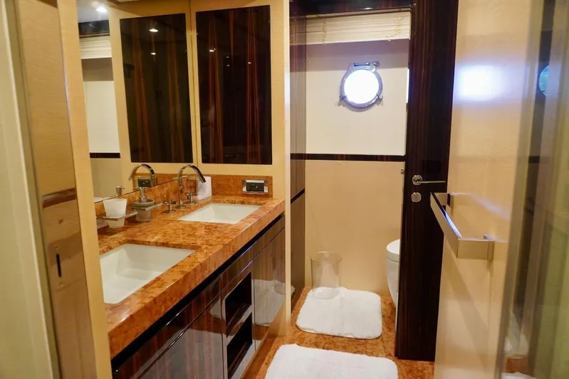  Yacht Photos Pics Luxurious bathroom in 2015 Azimut 84 yacht with dual sinks and elegant wood finishes.