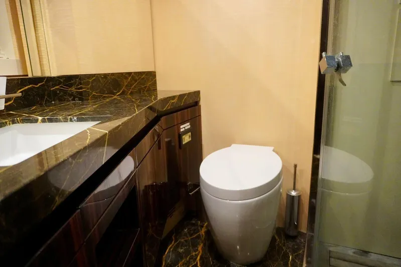  Yacht Photos Pics Luxurious bathroom in 2015 Azimut 84 yacht with marble countertop and modern fixtures.