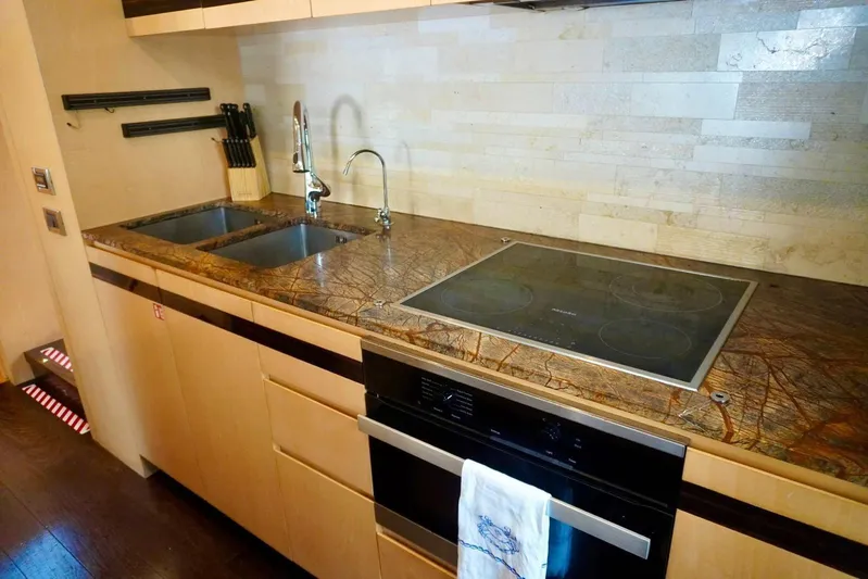  Yacht Photos Pics Luxurious kitchen in 2015 Azimut 84 yacht with modern appliances and elegant countertops.