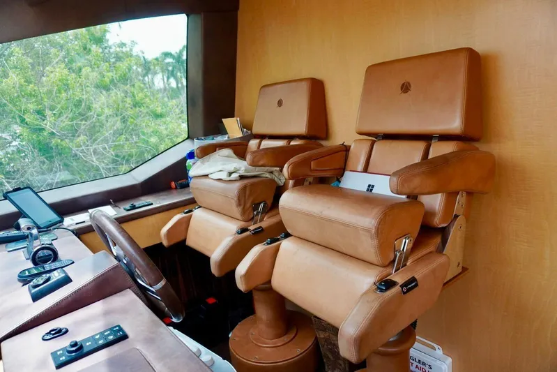  Yacht Photos Pics Luxurious leather helm seats in 2015 Azimut 84 yacht cockpit, featuring modern navigation equipment.