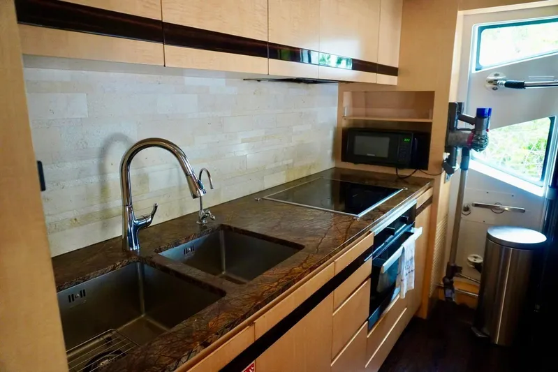  Yacht Photos Pics Modern kitchen in 2015 Azimut 84 yacht with sleek countertops and stainless steel appliances.