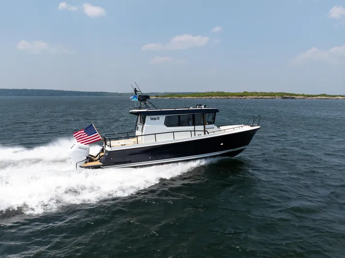 Stock 2 Yacht Photos Pics 2025 Targa 32 GT boat cruising on open water with American flag.