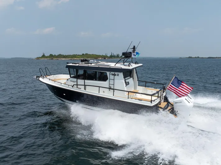 Stock 2 Yacht Photos Pics 2025 Targa 32 GT boat cruising on open water with American flag.