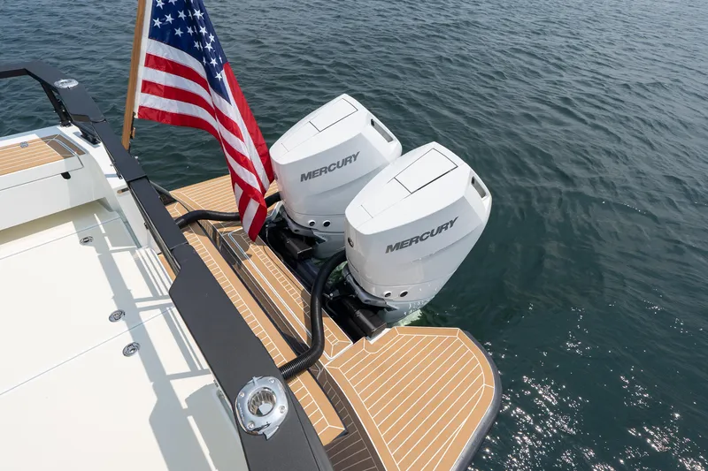 Stock 2 Yacht Photos Pics 2025 Targa 32 GT boat with dual Mercury engines and American flag on water.