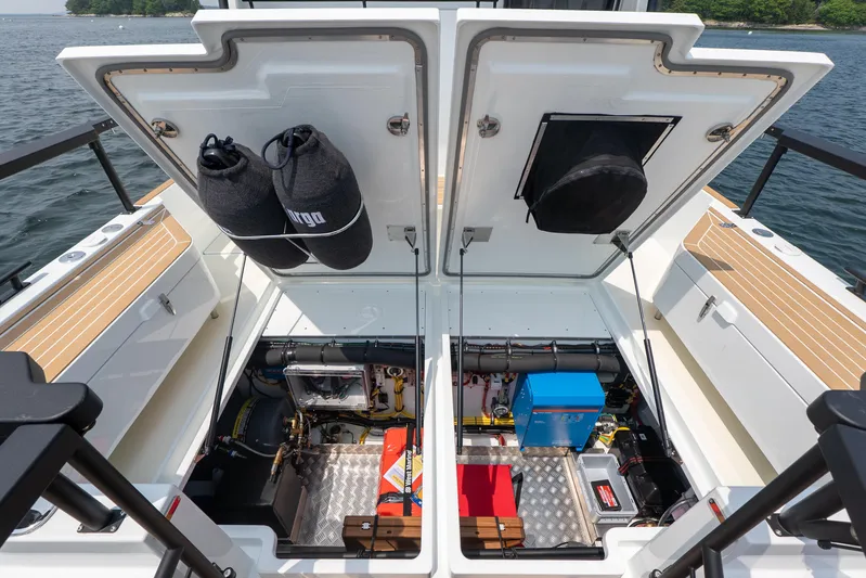 Stock 2 Yacht Photos Pics Open engine compartment of 2025 Targa 32 GT boat, showcasing storage and equipment.