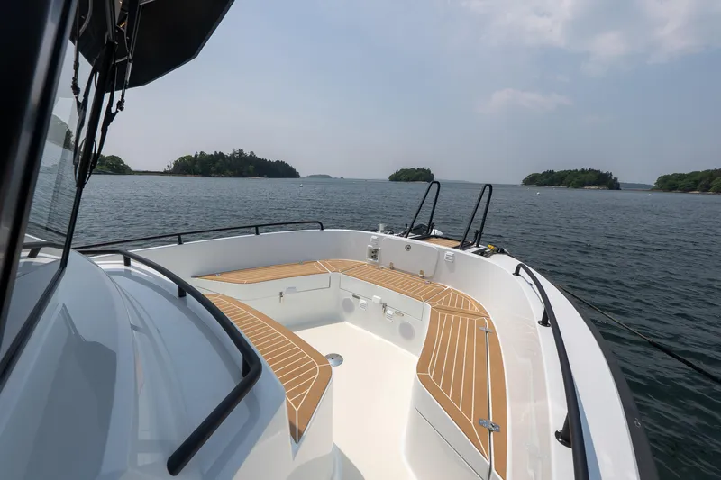 Stock 2 Yacht Photos Pics 2025 Targa 32 GT boat cruising on a serene lake with distant islands.
