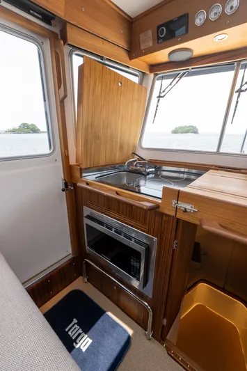 Stock 2 Yacht Photos Pics Interior of 2025 Targa 32 GT boat with wooden cabinetry and modern kitchen amenities.