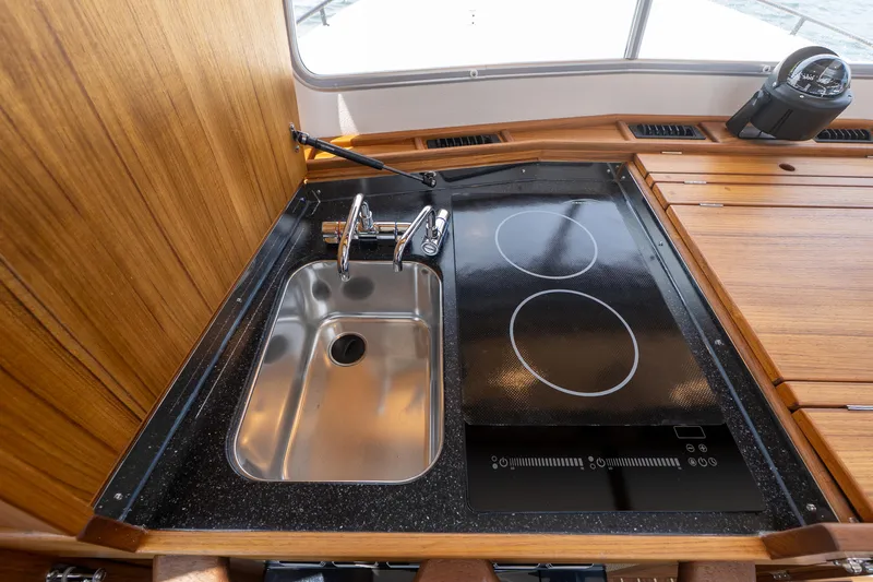 Stock 2 Yacht Photos Pics Modern kitchen area in 2025 Targa 32 GT boat with sink and stovetop.