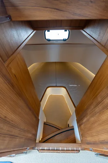 Stock 2 Yacht Photos Pics Interior view of 2025 Targa 32 GT boat with wooden finish and modern lighting.