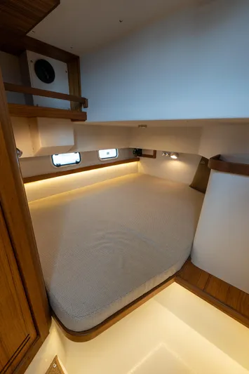 Stock 2 Yacht Photos Pics 2025 Targa 32 GT cabin interior with cozy bed and ambient lighting.