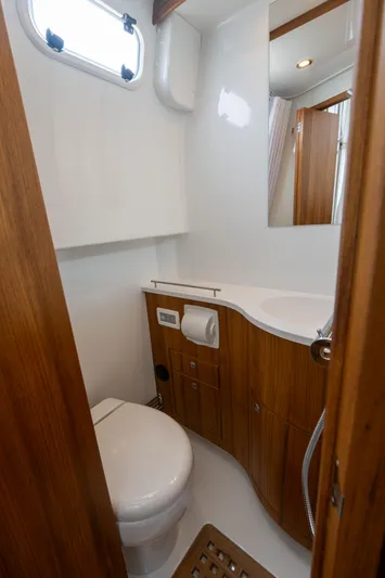 Stock 2 Yacht Photos Pics 2025 Targa 32 GT yacht bathroom with wooden cabinetry and modern fixtures.