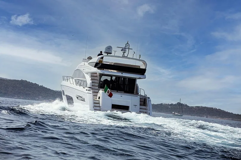  Yacht Photos Pics 2020 Princess F70 yacht cruising on open water under a clear blue sky.