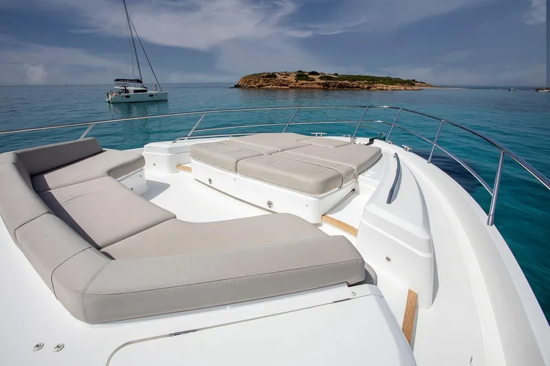 Yacht Photos Pics Luxury Princess F70 yacht deck with sun loungers, 2020 model, on serene turquoise waters.