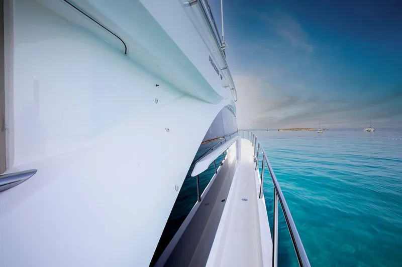  Yacht Photos Pics Side view of a 2020 Princess F70 yacht on clear blue water.